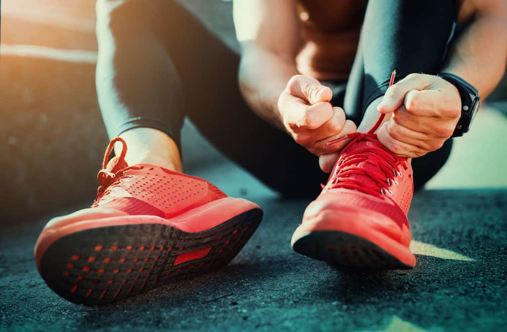 running tying shoes