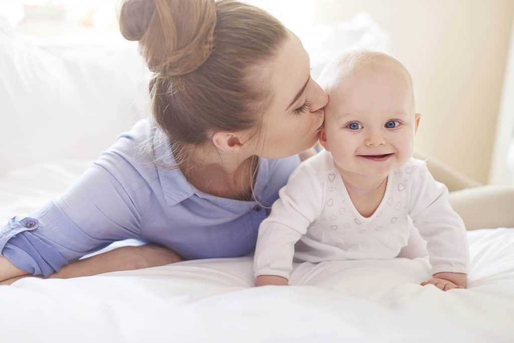 Woman kissing baby