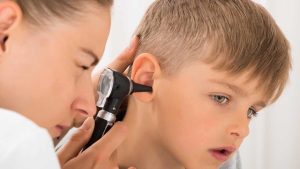 Doctor Examining Boy's Ear